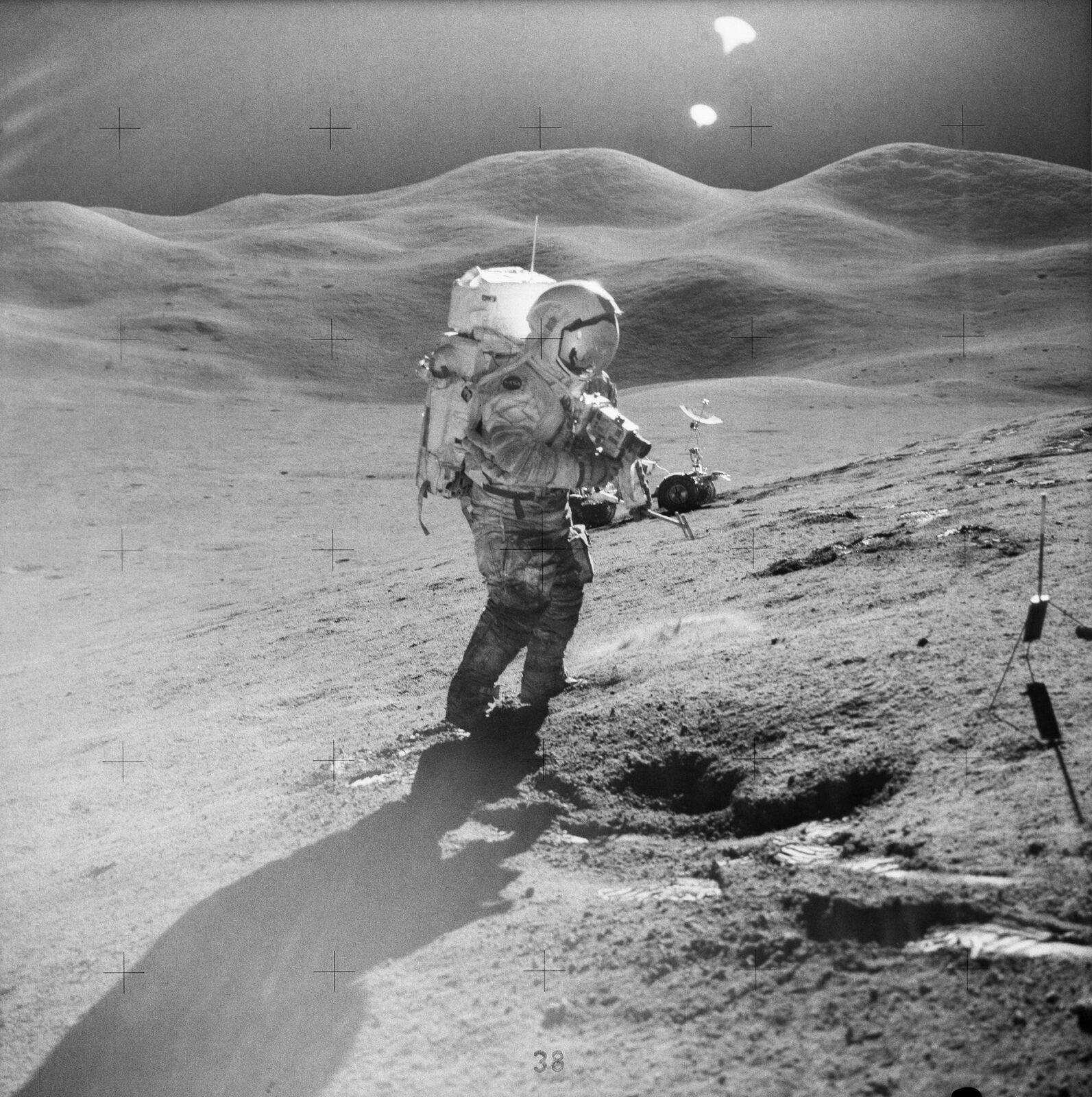David Scott on the slope of Hadley Delta in the A7-LB, the rover behind him, EVA 2